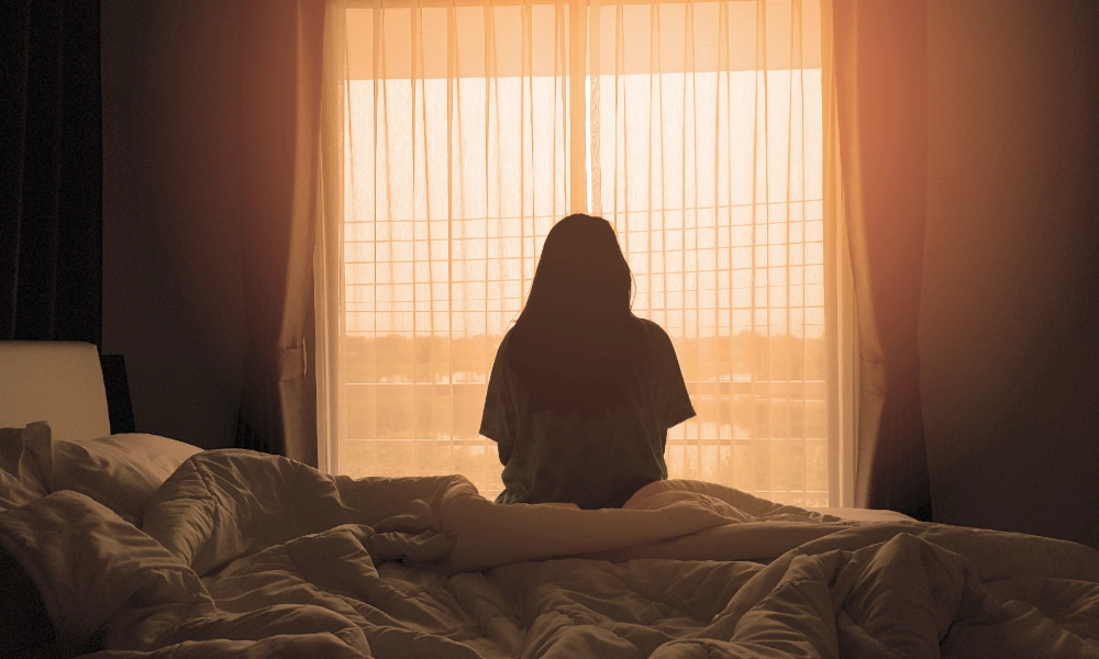 A woman sitting in front of a window